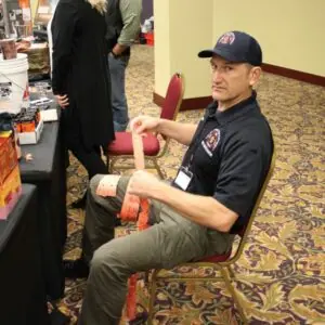Man seated at event booth organizing tickets.