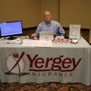 Man at Yergey Insurance information booth.