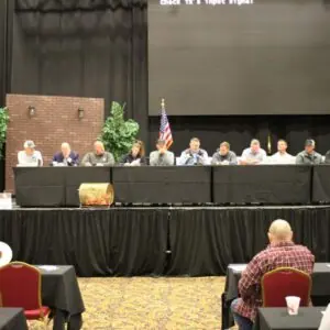 Panel discussion at a conference with attendees.