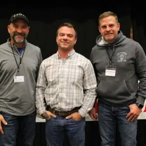 Three men at a community event.