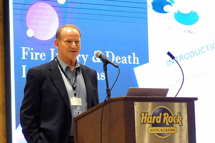 Man presenting at Fire Injury and Death Lessons conference.