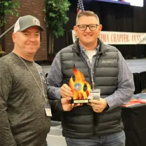Two men at an award ceremony.