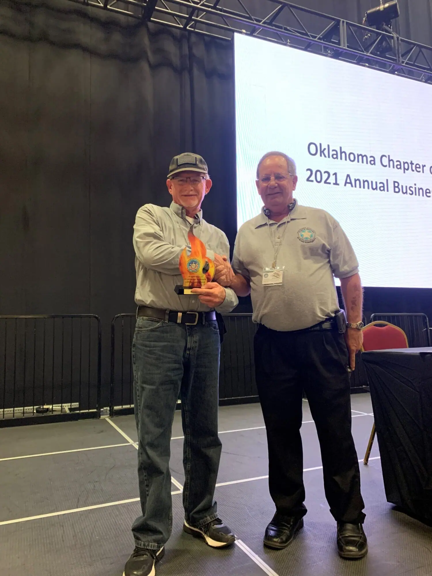 Two men with award at Oklahoma Chapter event, 2021.